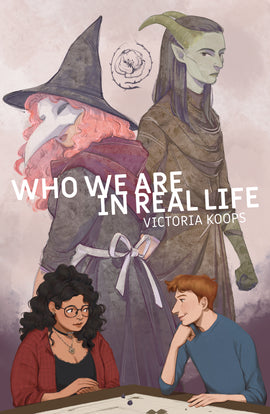  Who We Are in Real Life. Victoria Koops. Two teens sit at a gaming table. The girl has medium skin tone, dark curly hair and glasses, and wears a red plaid shirt over a black top. She looks over at the boy, who smiles back. He has red hair, pale skin tone and freckles. He wears a blue shirt. Above them, two fantasy characters appear back to back. One is a witch with a pointed black hat, a plague mask and pink hair. The other is a tiefling rogue with gray skin, horns and long black hair. 