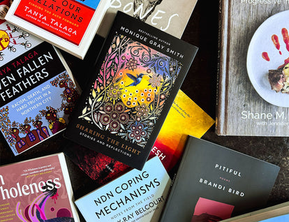A collection of various House of Anansi Press books by Indigenous authors arranged on a concrete background. 
