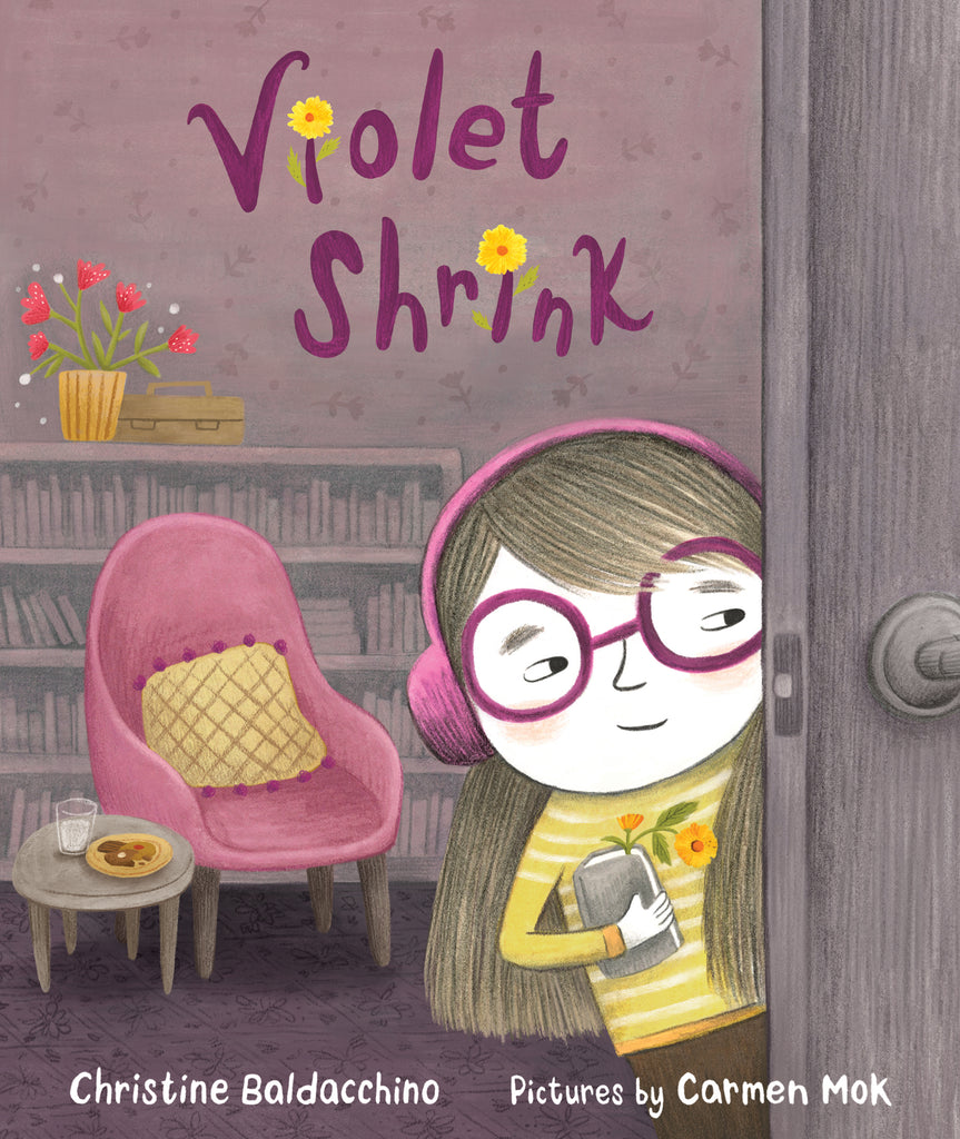  An open door shows the view into a living room with a bookshelf, a sitting chair, and a side table with cookies and milk on it. A girl with light skin tone and brown hair looks around the open door from inside the living room. She wears purple glasses, purple headphones, and a yellow-striped sweater. She carries a book with a yellow flower between the pages as a bookmark. When the title has a letter “I” it is dotted with this yellow flower. Text: Violet Shrink. Christine Baldacchino. Pictures by Carmen Mok. 