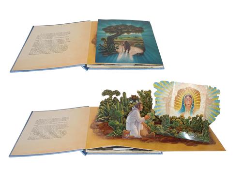  This image shows a pop-up book in two photographs. The first photo is open to a flat page. The second photo is open to a pop-up of a desert with many cactus plants. A man with medium skin tone is kneeling among the plants. An image of a woman surrounded by clouds and rays of light wearing a blue head scarf rises out of the plants. 