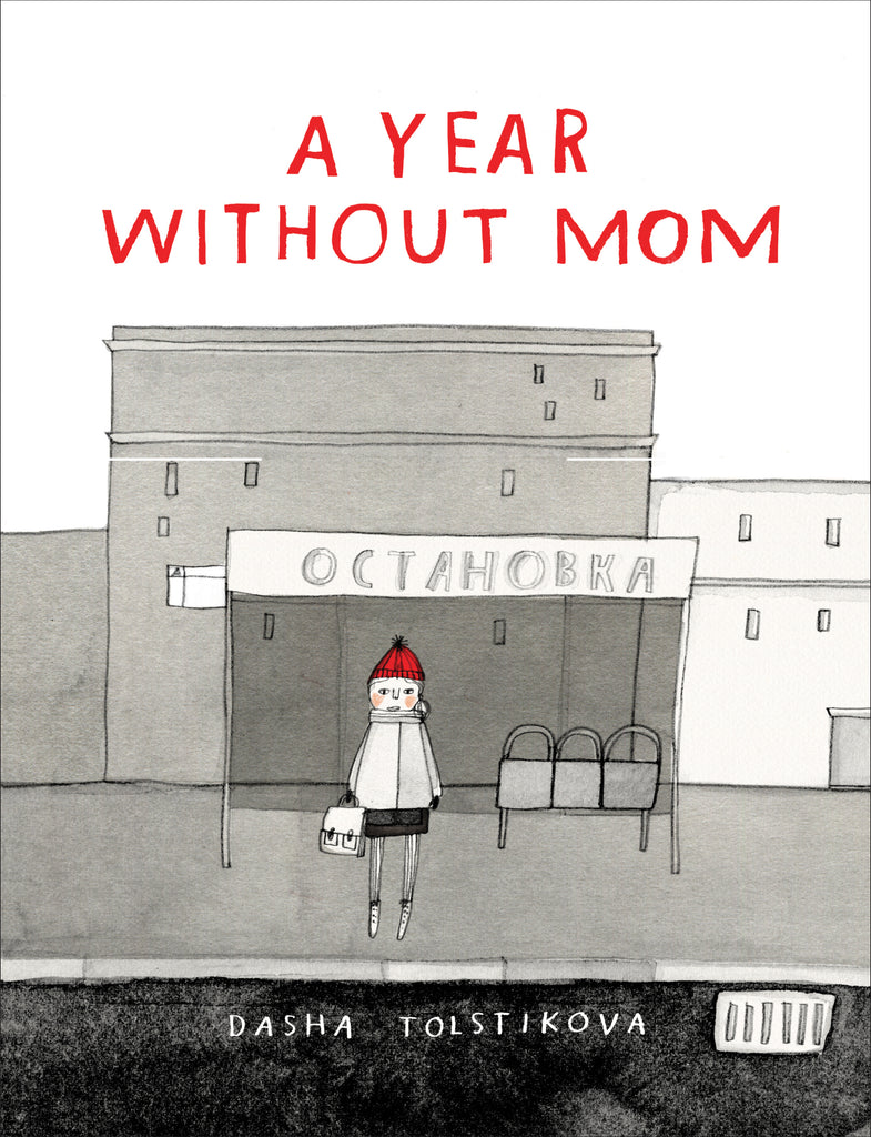  This image is in shades of black and white. A child with light skin tone stands in front of a public transit stop in front of a few short buildings. They are in winter clothes with a red hat. The stop has a sign over it written in a Slavic language. Text: A Year Without Mom. Dasha Tolstikova. 