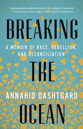  Small glittering, gold shapes are against a light blue background. The shapes appear to drop from the top of the cover, where they fall into place to form mandala-like patterns at the bottom of the cover. Text: Breaking the Ocean. A Memoir of Race, Rebellion, and Reconciliation. Annahid Dashtgard. “A profound and candid reflection on the realities of race today.” – Waubgeshig Rice, author of Moon of the Crusted Snow. 